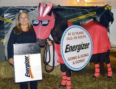 Horse Halloween costume. The horse is dressed up as the energizer bunny. The woman is dressed like a battery.