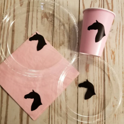 Horse plates from Partyof7Creations. It shows two clear plastic plates with the silhouette of a horse head in the center. There is also a pink napkin and cup with the same image.