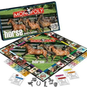 Horse Lover's Monopoly board game. The picture shows the top of the board game box along with the actual board and the different elements used in the game.