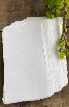 A picture of a stack of cotton paper with a branch.
