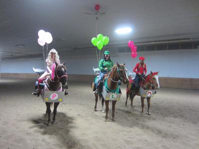 Three horses and riders. Each rider is dressed as a Mario Kart character and each horse is dressed as a race car.