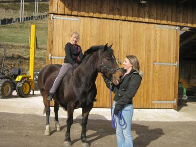 Me riding Poppet Bareback with my sister holding her.