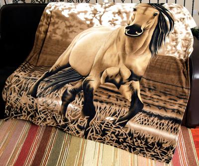 A blanket with a buckskin horse and background made up of brown, tan, and white colors in a variety of patterns in different stripes.