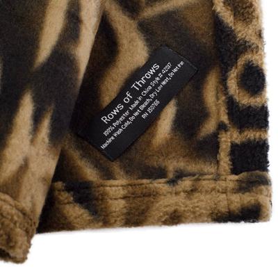 A picture of the tag on the blanket. It says Rows of Throws 100% polyester made in China style #02017 machine wash cold, do not bleach, dry low heat, do not iron, RN 150766.