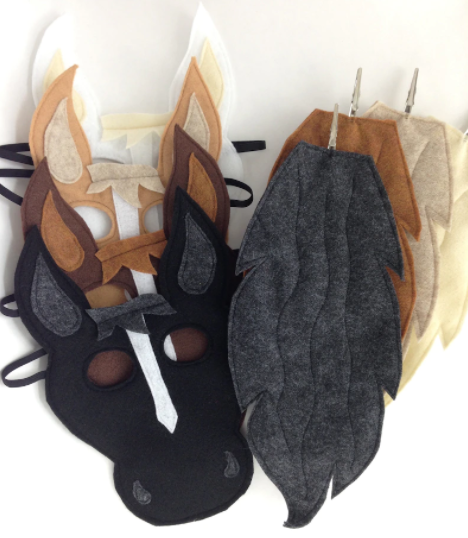 Four horse masks and tails all in different colors.