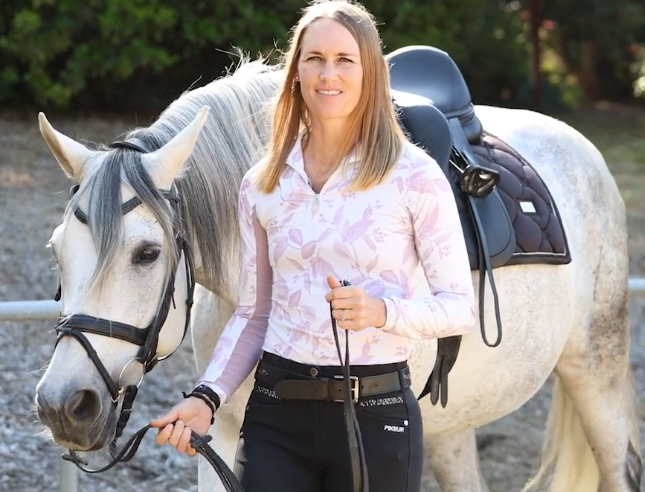 Image from Amelia Newcomb's 30 day to round challenge page. Features a women leading a dapple grey horse.