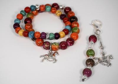 Two bracelets and a charm. The two bracelets are made up of different colored beads and one has a horse charm on it. The charm is a horse with a string of colored beads.