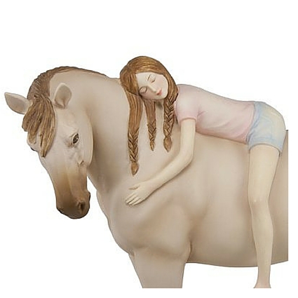A horse collectible featuring a girl on laying on her horse's back giving the horse a hug.