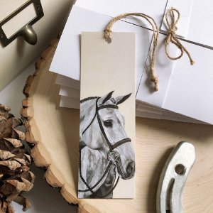 A bookmark with a horse head design on it.