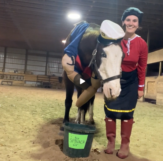 A horse dressed as popeye and a woman dressed as Olive Oil the character in Popeye