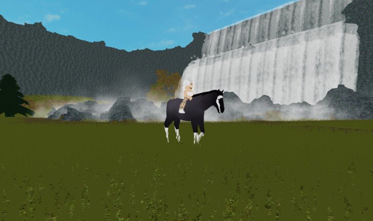 An image of a horse on a green field with a waterfall in the background