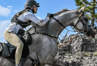 Image from The Sweaty Equestrian of a woman riding a grey horse